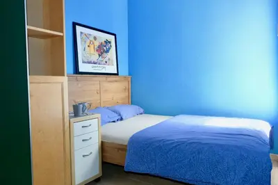 a bedroom with a bed and a blue wall at Apartment Port Forum in Barcelona