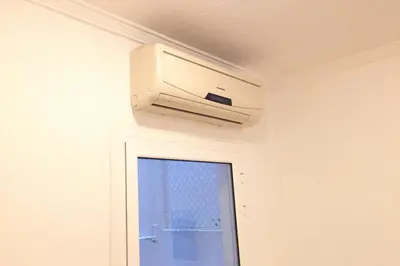 a air conditioner on a wall next to a window at NEW! Cute apartment near metro in Barcelona