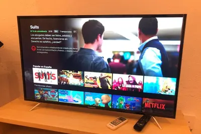 a flat screen tv sitting on top of a wooden shelf at NEW! Cute apartment near metro in Barcelona