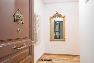 a mirror on a wall next to a door at Alcam Urgell in Barcelona