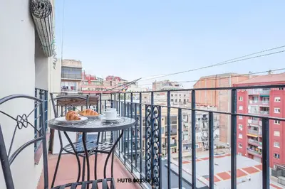 a table with a cup of coffee on a balcony at Alcam Urgell in Barcelona