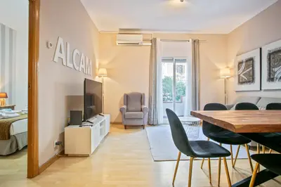 a living room with a dining table and a bedroom at Alcam Calabria in Barcelona