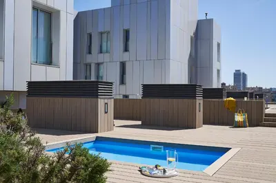 a swimming pool on the roof of a building at Lugaris Beach Apartments in Barcelona