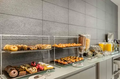 a buffet with many different types of bread and pastries at Ikonik Lex in Hospitalet de Llobregat
