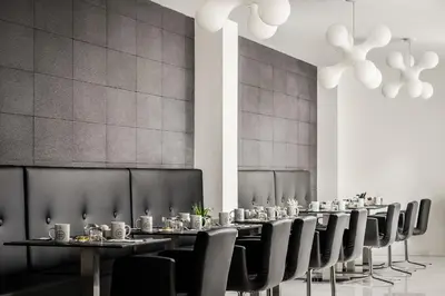 a row of tables and chairs in a room at Ikonik Lex in Hospitalet de Llobregat