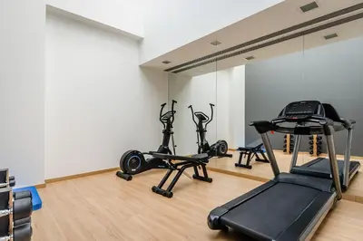 a gym with three exercise bikes in a room at Ikonik Lex in Hospitalet de Llobregat