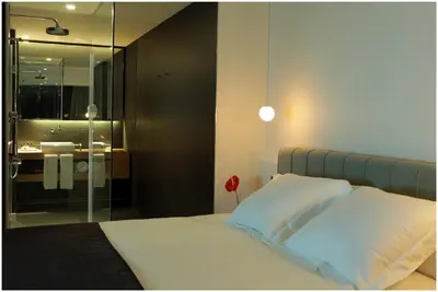a bedroom with a bed and a bathroom with a sink at Ohla Barcelona in Barcelona