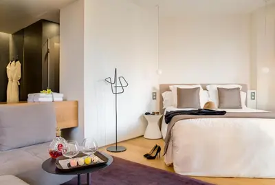 a bedroom with a bed and a table with wine glasses at Ohla Barcelona in Barcelona
