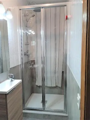 a shower with a glass door in a bathroom at BCN 324 Apartment in Barcelona