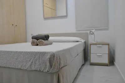 a bedroom with a bed with two towels on it at BCN 324 Apartment in Barcelona