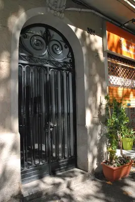 an entrance to a building with a black gate at BCN 324 Apartment in Barcelona
