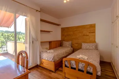 a bedroom with a bed and a desk and a table at Les Canyes Cottage, Private Villa Resort in Piera