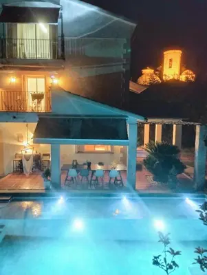 a swimming pool in front of a house at night at Les Canyes Cottage, Private Villa Resort in Piera