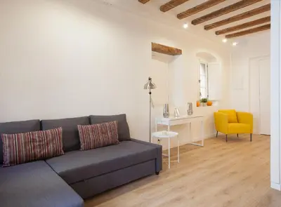 a living room with a couch and a yellow chair at Alsina · Historical center - Barrio Gótico in Barcelona
