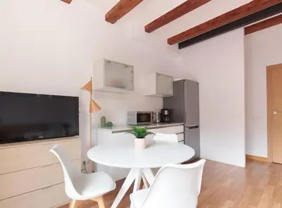 a white dining room with a white table and chairs at Spacious doubleroom apartment at Sants in Barcelona
