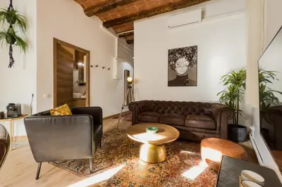 a living room with a couch and a table at Magalhaes · Trad flat in Poble Sec, near ramblas in Barcelona