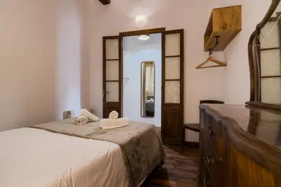 a bedroom with a bed with a mirror and a dresser at Magalhaes · Trad flat in Poble Sec, near ramblas in Barcelona