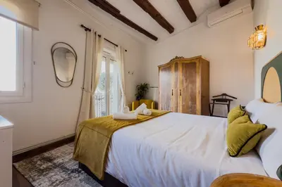 a bedroom with a large white bed and a window at Magalhaes · Trad flat in Poble Sec, near ramblas in Barcelona