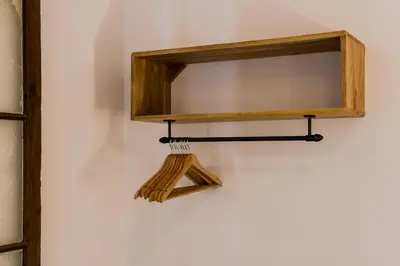 a wooden shelf with a broom on a wall at Magalhaes · Trad flat in Poble Sec, near ramblas in Barcelona