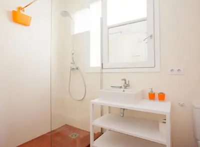 a white bathroom with a sink and a shower at Pere IV · New & modern apartment close to beach in Barcelona