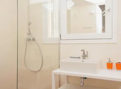 a white bathroom with a sink and a shower at Pere IV · New & modern apartment close to beach in Barcelona