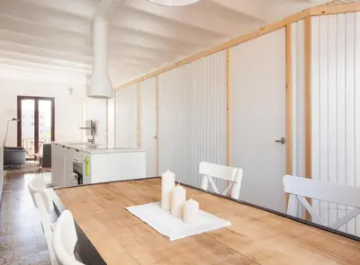 a kitchen and dining room with a table and chairs at Pere IV · New & modern apartment close to beach in Barcelona