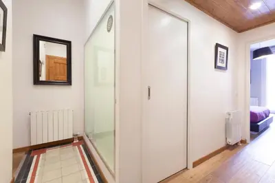 a hallway with a glass door and a mirror at Akira Flats Roger de Flor Chic apartment in Barcelona
