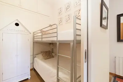 a small bedroom with a bunk bed and a bunk bed at Akira Flats Roger de Flor Chic apartment in Barcelona