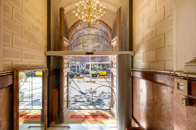 an open door into a building with a chandelier at Apartments Sixtyfour in Barcelona