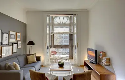 a living room with a couch and a tv at Apartments Sixtyfour in Barcelona