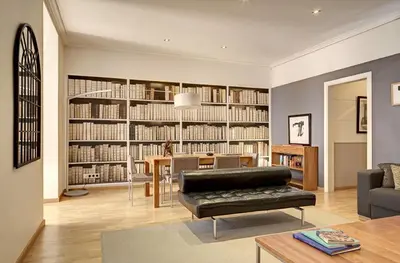 a living room with a library with a couch and a table at Apartments Sixtyfour in Barcelona