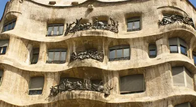 a building with statues on the side of it at Apartments Sixtyfour in Barcelona