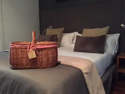 a wicker basket sitting on top of a bed at Apartments Sixtyfour in Barcelona