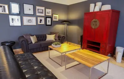 a living room with a couch and a red cabinet at Apartments Sixtyfour in Barcelona