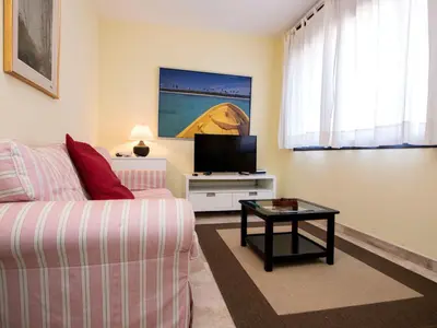 a living room with a couch and a tv at Apartment Vila Olímpica- Sant Martí - Sardenya by Interhome in Barcelona
