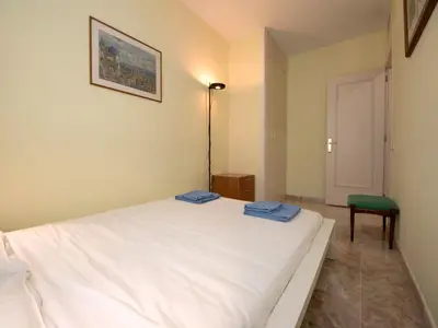 a bedroom with a white bed with blue towels on it at Apartment Vila Olímpica- Sant Martí - Sardenya by Interhome in Barcelona