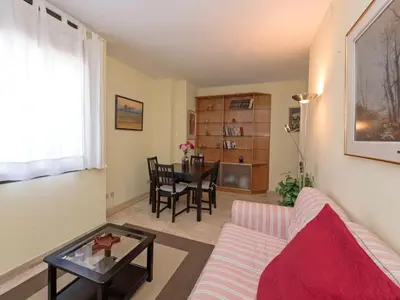 a living room with a couch and a table at Apartment Vila Olímpica- Sant Martí - Sardenya by Interhome in Barcelona