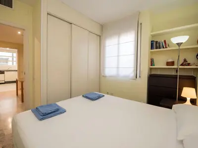 a bedroom with a white bed with two blue towels on it at Apartment Vila Olímpica- Sant Martí - Sardenya by Interhome in Barcelona