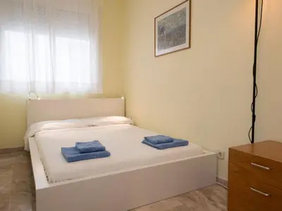 a bedroom with a bed with two blue towels on it at Apartment Vila Olímpica- Sant Martí - Sardenya by Interhome in Barcelona