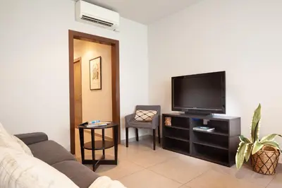 a living room with a couch and a flat screen tv at EasySleep Eixample in Barcelona