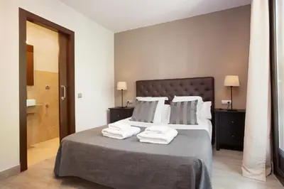 a bedroom with a bed with towels on it at EasySleep Eixample in Barcelona