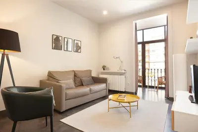 a living room with a couch and a table at EasySleep Gaudi Terrace in Barcelona