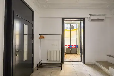 a hallway with a black door and a tile floor at Ella Hostel Gran Vía in Barcelona