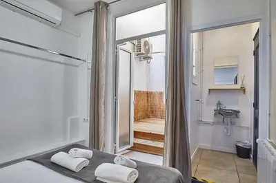 a bathroom with a bed with towels on it at Ella Hostel Gran Vía in Barcelona