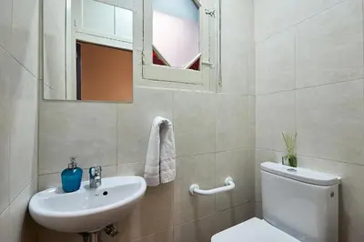 a bathroom with a toilet and a sink and a mirror at Ella Hostel Gran Vía in Barcelona