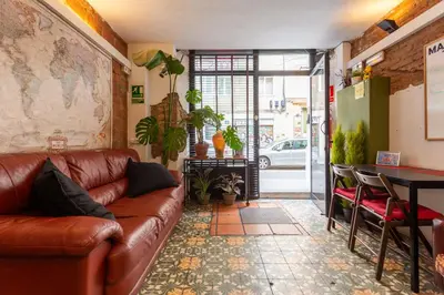a living room with a leather couch and a table at Mambo Tango in Barcelona