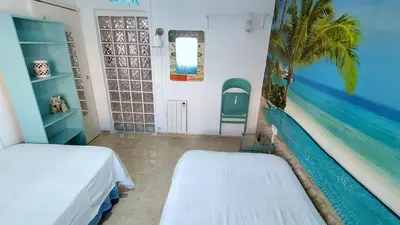 a room with two beds and a swimming pool on the wall at Hawaii Fira Barcelona in Hospitalet de Llobregat