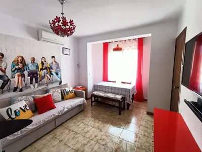a group of people sitting on a wall in a living room at Hawaii Fira Barcelona in Hospitalet de Llobregat
