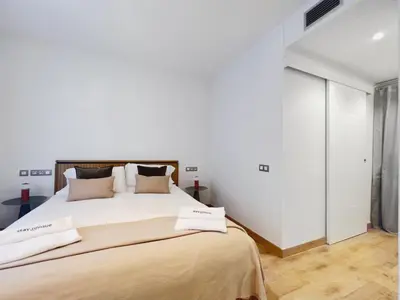 a bedroom with a large bed with two towels on it at Stay U-nique Apartments Urquinaona II in Barcelona