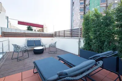 a balcony with two chairs and a table on a building at Stay U-nique Apartments Urquinaona II in Barcelona